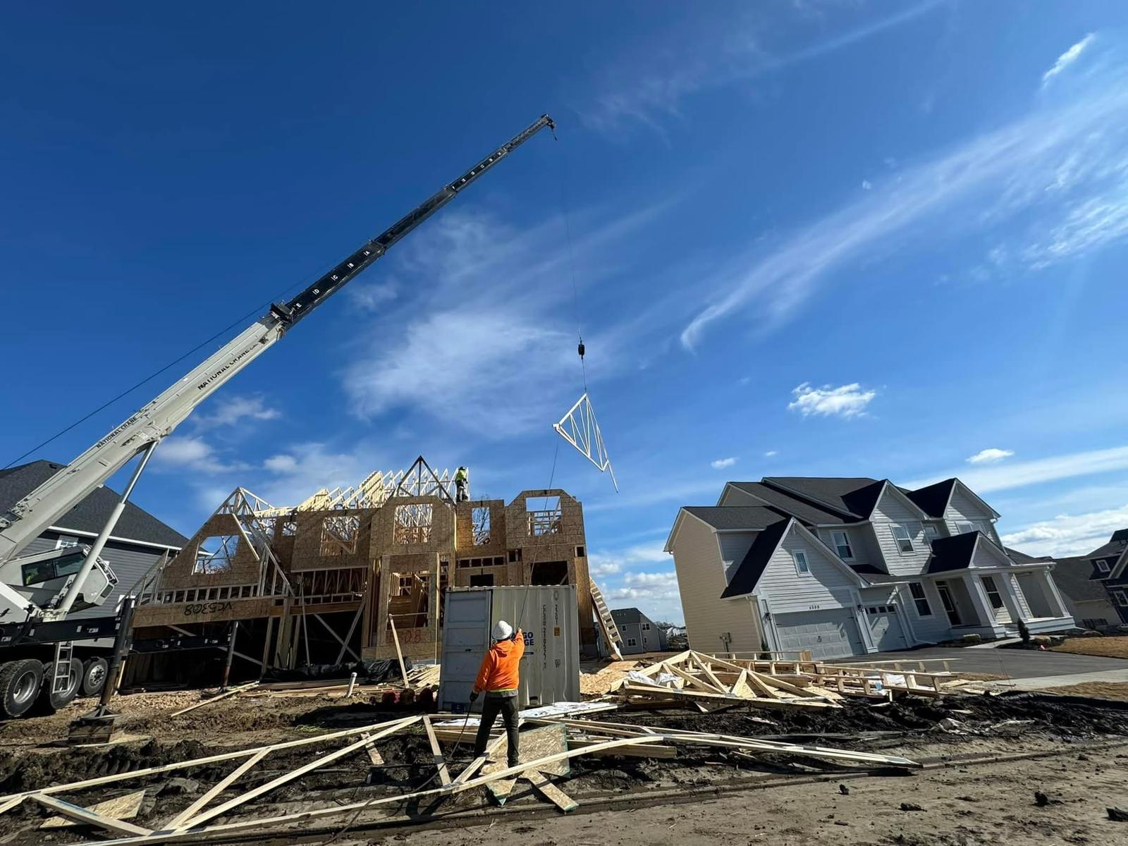 Construction framing crew reviewing blueprints